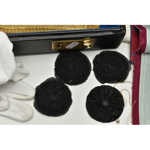 108 - A BLACK BRIEFCASE WITH MASONIC REGLIA, to include four sashes some with medallions, six aprons, whit... 