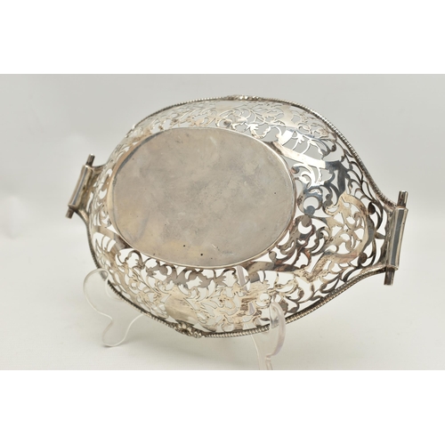 165 - AN EARLY 20TH CENTURY PIERCED DISH, oval form with pierced rims and vacant cartouches, scroll handle... 