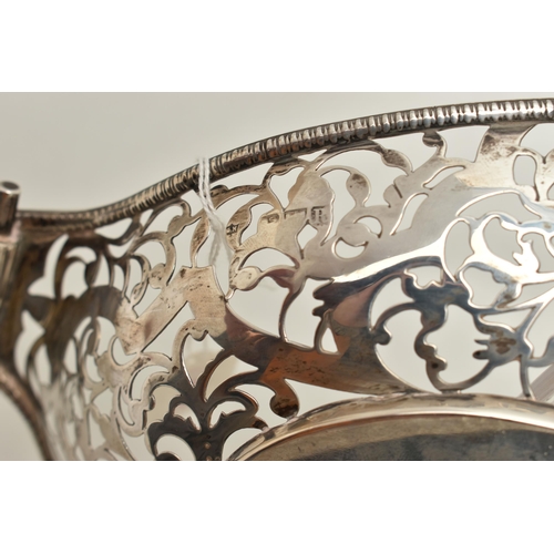 165 - AN EARLY 20TH CENTURY PIERCED DISH, oval form with pierced rims and vacant cartouches, scroll handle... 