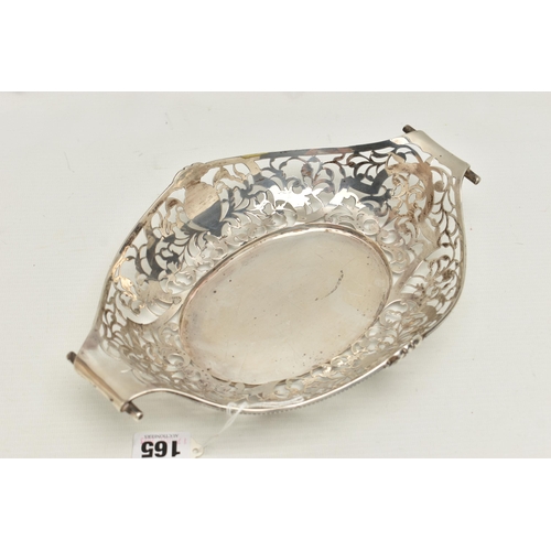 165 - AN EARLY 20TH CENTURY PIERCED DISH, oval form with pierced rims and vacant cartouches, scroll handle... 