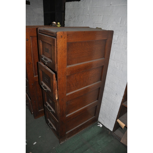 888 - AN EARLY 29th CENTURY OAK FILING CABINET with four drawers, brass handles and card holders, panelled... 