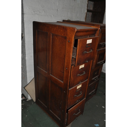 889 - AN EARLY 29th CENTURY OAK FILING CABINET with four drawers, brass handles and card holders, panelled... 