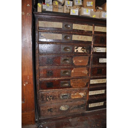 925 - AN EDWARDIAN MAHOGANY HARBERDASHERS CHEST OF TWENTY FOUR DRAWERS with campaign handles to all but on... 