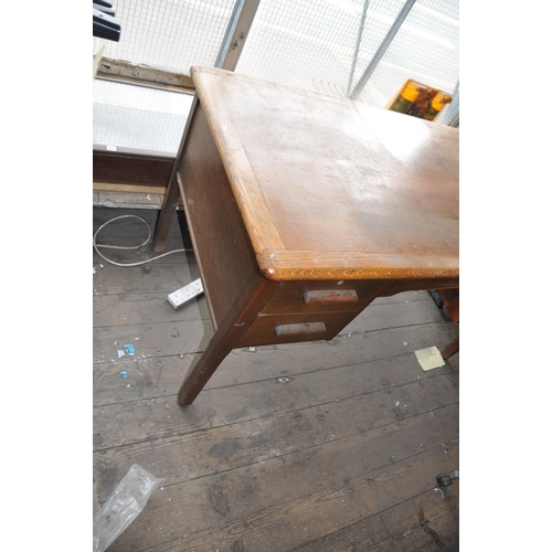 994 - AN EARLY 20th CENTURY OAK DESK with two drawers either side of open knee hole standing on square leg... 