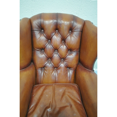 1324 - A PAIR OF OSKAR TETRAD TANNED LEATHER WING BACK ARMCHAIRS, with buttoned back and studded detail to ... 