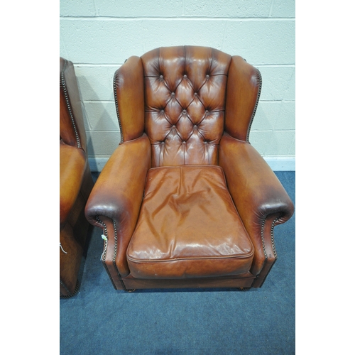 1324 - A PAIR OF OSKAR TETRAD TANNED LEATHER WING BACK ARMCHAIRS, with buttoned back and studded detail to ... 