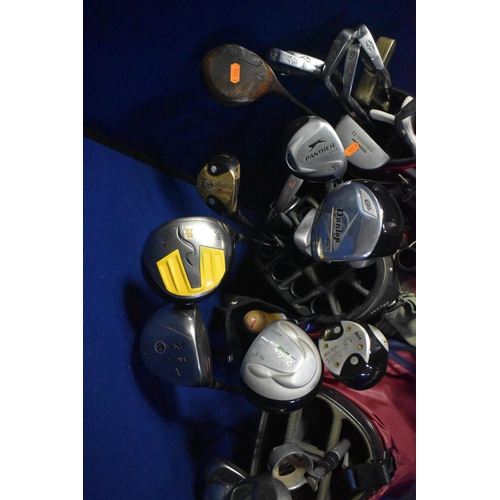 1055 - THREE GOLF BAGS containing various golf clubs to include Dunlop, Mitsushiba, Slazenger etc together ... 