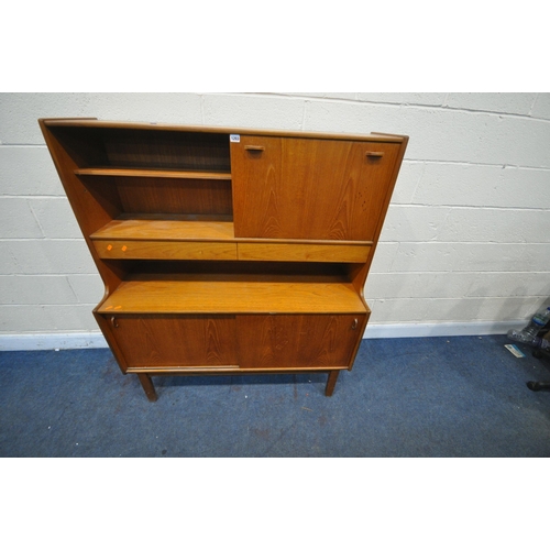 1203 - A MID CENTURY NATHAN TEAK HIGHBOARD, with an open bookcase section next to a fall front door, above ... 