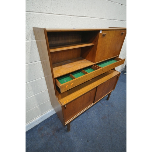 1203 - A MID CENTURY NATHAN TEAK HIGHBOARD, with an open bookcase section next to a fall front door, above ... 