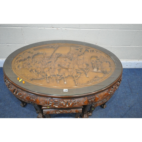 1206 - AN ORIENTAL CARVED OVAL COFFEE TABLE, with a sit on glass top, along with six smaller tables underne... 