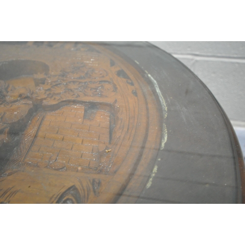 1206 - AN ORIENTAL CARVED OVAL COFFEE TABLE, with a sit on glass top, along with six smaller tables underne... 