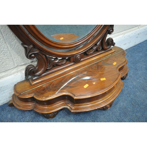 1245 - A VICTORIAN FLAME MAHOGANY OVAL BEVELLED EDGE SWING TOILET MIRROR, with foliate details, with a cent... 