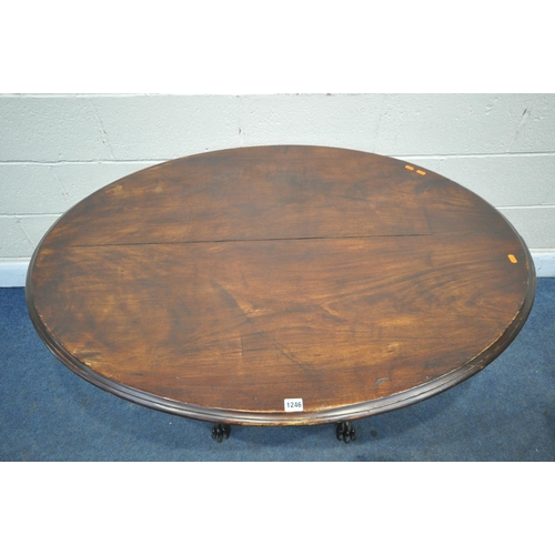 1246 - A LATE 19TH/EARLY 20TH CENTURY OVAL CENTRE TABLE, the mahogany top on an ebonised base, with spiral ... 