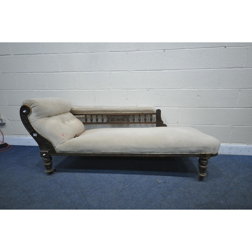 1270 - A 20TH CENTURY OAK CHAISE LONGUE, the back with spindle supports and foliate central design, beige u... 