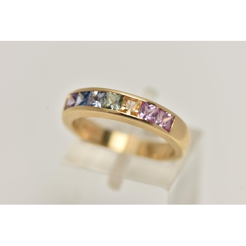 11 - AN 18CT GOLD MULTI GEM RING, set with seven square cut gems in a channel setting, including sapphire... 