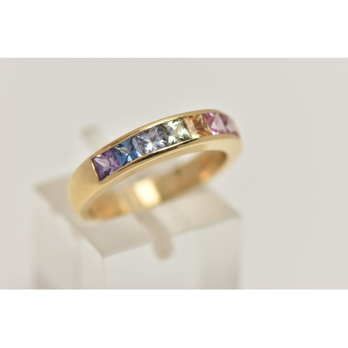 11 - AN 18CT GOLD MULTI GEM RING, set with seven square cut gems in a channel setting, including sapphire... 