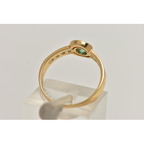 12 - AN 18CT GOLD EMERALD AND DIAMOND RING, designed as a central oval emerald flanked by brilliant cut d... 