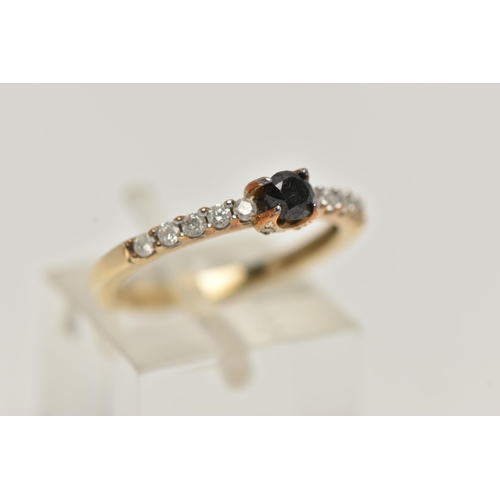 2 - A DIAMOND RING, designed as a central brilliant cut treated black diamond in a four claw setting wit... 