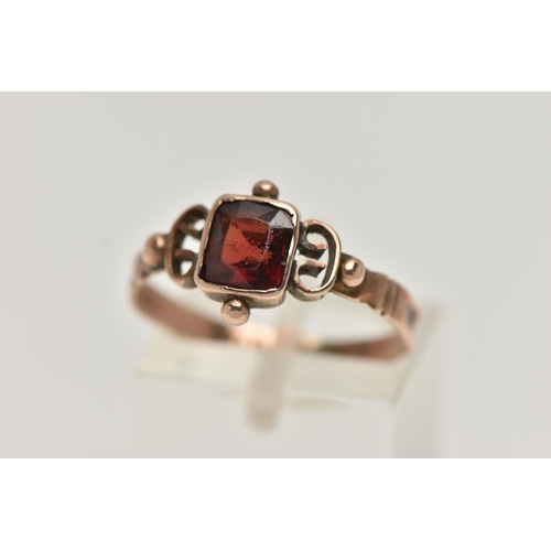 30 - AN EARLY VICTORIAN YELLOW METAL GARNET RING, designed with a square cut garnet, collet set, applied ... 