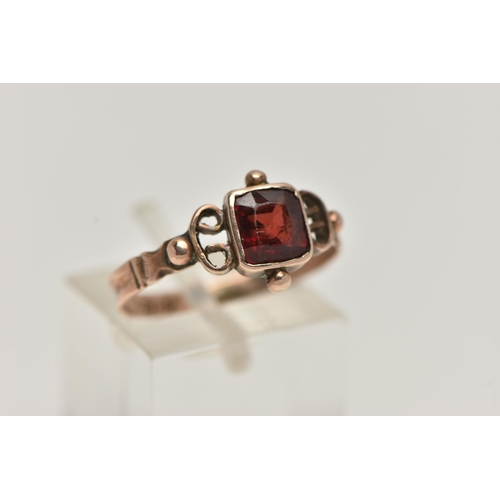 30 - AN EARLY VICTORIAN YELLOW METAL GARNET RING, designed with a square cut garnet, collet set, applied ... 