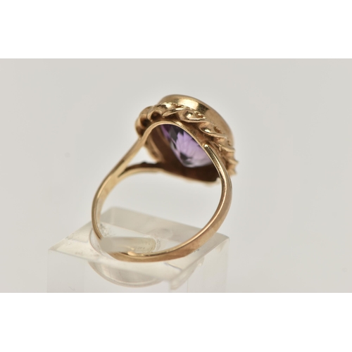 31 - A 9CT GOLD AMETHYST RING AND A PAIR OF AMETHYST EARRINGS, the ring of an oval form set with an oval ... 