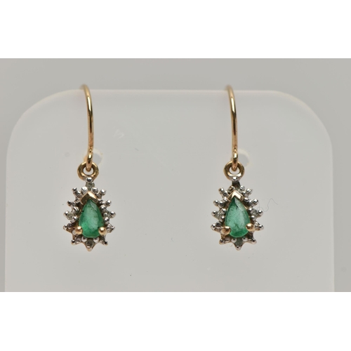 32 - A PAIR OF EMERALD DROP EARRINGS, each earring set with a pear cut emerald, within a surround of smal... 