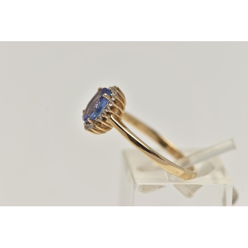 9 - A 9CT GOLD GEM CLUSTER RING, designed as a central oval tanzanite within a circular cut colourless g... 