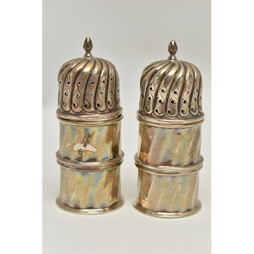 104 - A PAIR OF EDWARDIAN SILVER PEPPERETTES OF DOMED CYLINDRICAL FORM, pull off covers, panelled sides of... 