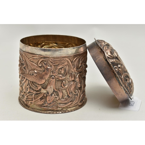 118 - A VICTORIA I EMBOSSED SILVER POT, a cylindrical pot embossed with birds and a floral and foliage des... 