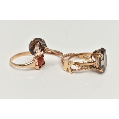 95 - FOUR 9CT GOLD RINGS, to include a coral set signet ring, two smoky quartz set rings, and an initial ... 
