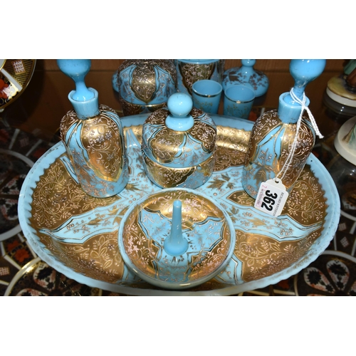 362 - A VICTORIAN TURQUOISE MILK GLASS AND GOLD GILT DRESSING TABLE/VANITY SET, decorated with a raised fl... 