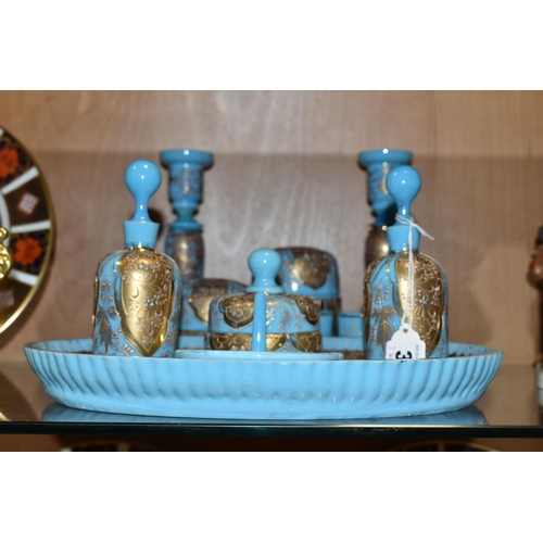 362 - A VICTORIAN TURQUOISE MILK GLASS AND GOLD GILT DRESSING TABLE/VANITY SET, decorated with a raised fl... 