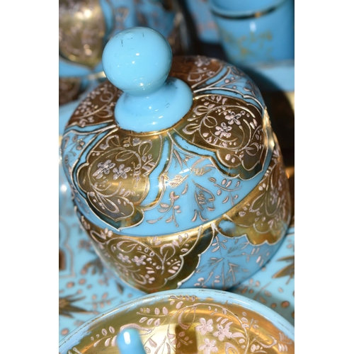 362 - A VICTORIAN TURQUOISE MILK GLASS AND GOLD GILT DRESSING TABLE/VANITY SET, decorated with a raised fl... 