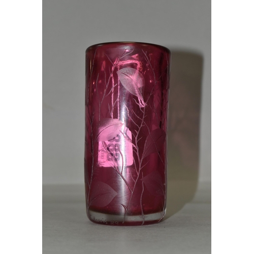 388 - TWO PIECES OF CRANBERRY GLASS, to include a cylindrical vase etched with leaves, signed '(Jonathan?)... 