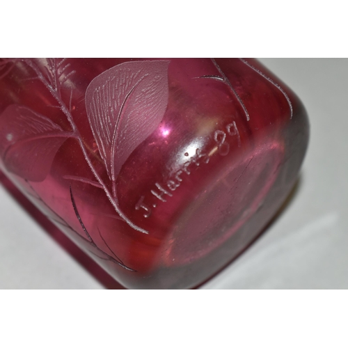 388 - TWO PIECES OF CRANBERRY GLASS, to include a cylindrical vase etched with leaves, signed '(Jonathan?)... 