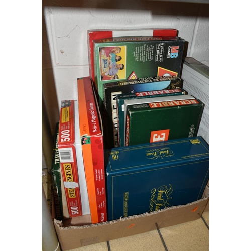 403 - THREE BOXES OF TOYS AND GAMES, to include eleven jigsaw puzzles, games including Master Mind, Scrabb... 