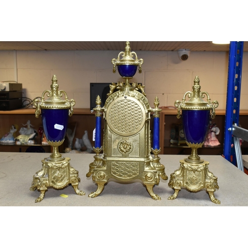 416 - A 20TH CENTURY BRASS AND PORCELAIN CLOCK GARNITURE, the porcelain panels transfer printed with coupl... 