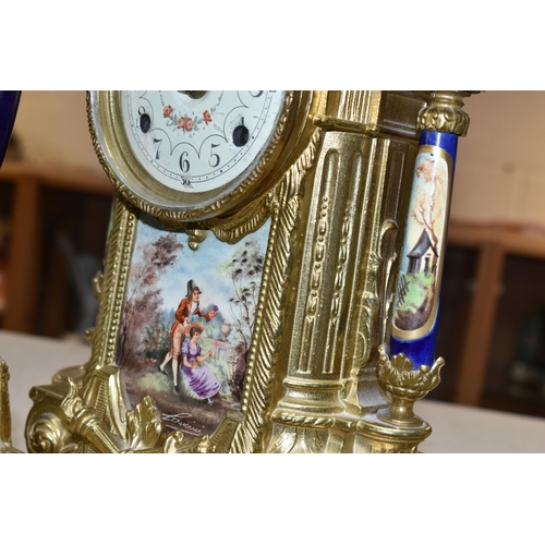 416 - A 20TH CENTURY BRASS AND PORCELAIN CLOCK GARNITURE, the porcelain panels transfer printed with coupl... 