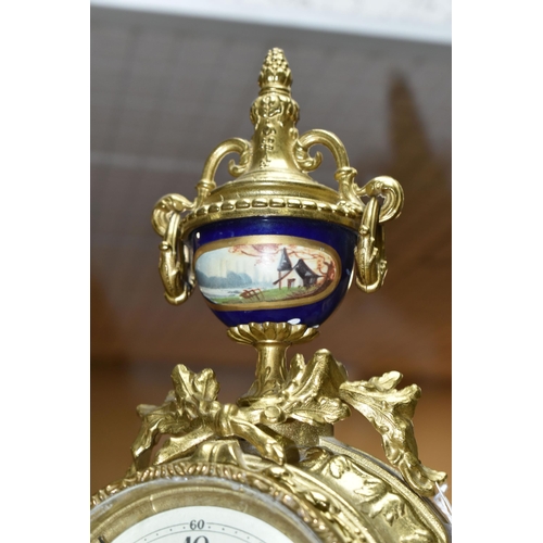 416 - A 20TH CENTURY BRASS AND PORCELAIN CLOCK GARNITURE, the porcelain panels transfer printed with coupl... 