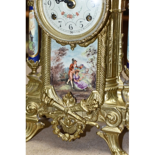 416 - A 20TH CENTURY BRASS AND PORCELAIN CLOCK GARNITURE, the porcelain panels transfer printed with coupl... 