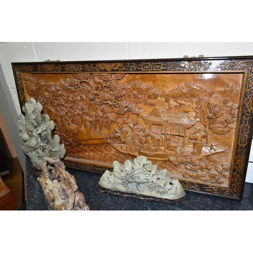 431 - A LARGE ORIENTAL CAMPHOR WOOD WALL HANGING AND FOUR ORIENTAL CARVED STONE ORNAMENTS, comprising a la... 