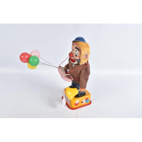 116 - A BOXED YONEZAWA BATTERY OPERATED TINPLATE BALLOON VENDOR, not tested, tinplate base with dressed fi... 