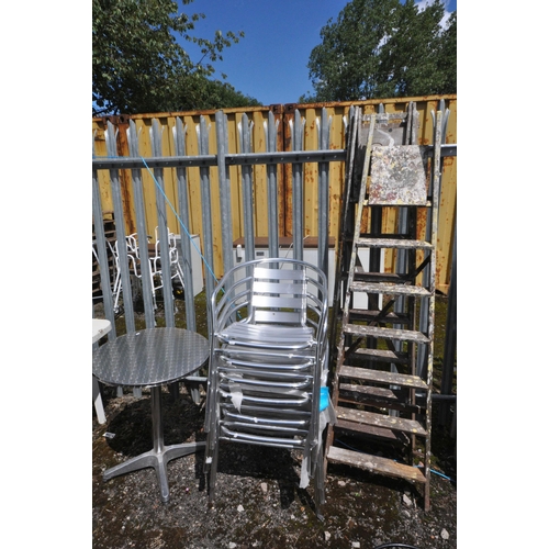 1003 - AN ALUMINIUM BISTRO TABLE, diameter 60cm x height 72cm, four armchairs, along with a metal curved be... 