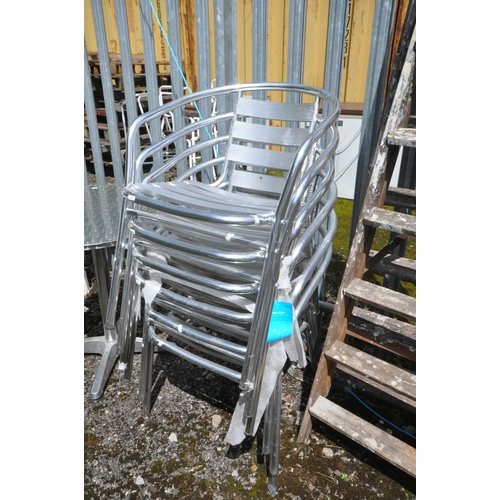 1003 - AN ALUMINIUM BISTRO TABLE, diameter 60cm x height 72cm, four armchairs, along with a metal curved be... 