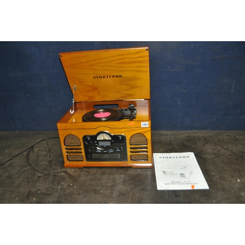 1064 - A STORTFORD MODEL 8714 RETRO MUSIC PLAYER with a golden oak finish, with manual (PAT pass and workin... 