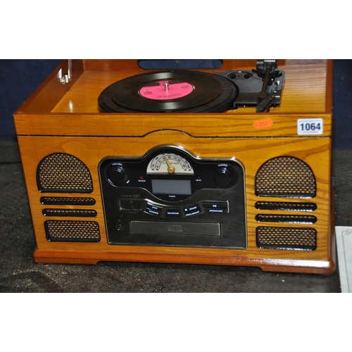 1064 - A STORTFORD MODEL 8714 RETRO MUSIC PLAYER with a golden oak finish, with manual (PAT pass and workin... 