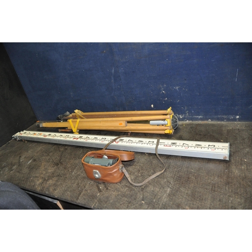 1121 - A SURVEYORS LEVEL IN LEATHER EFFECT CASE along with a tripos and measure (3)