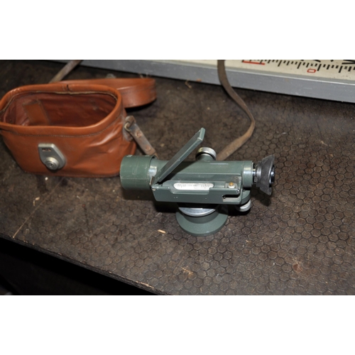 1121 - A SURVEYORS LEVEL IN LEATHER EFFECT CASE along with a tripos and measure (3)