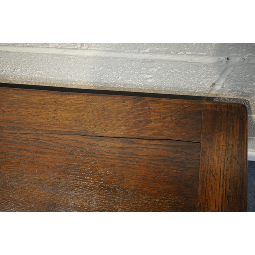 1199 - A REPRODUCTION OAK TRESTLE DRAW LEAF DINING TABLE, on square tapered legs, with foliate detailing, o... 