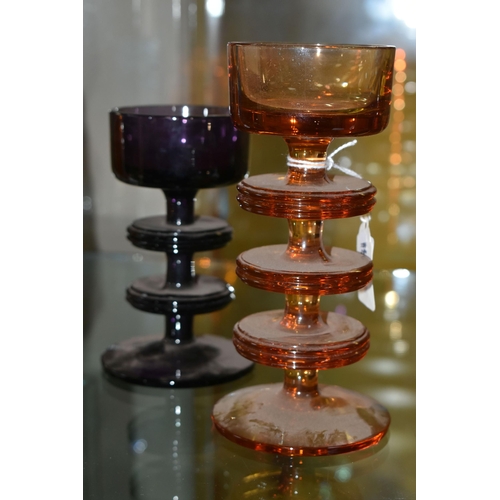 614 - TWO RONALD STENNETT-WILSON FOR WEDGWOOD SHERINGHAM COLOURED GLASS CANDLEHOLDERS, the amethyst glass ... 